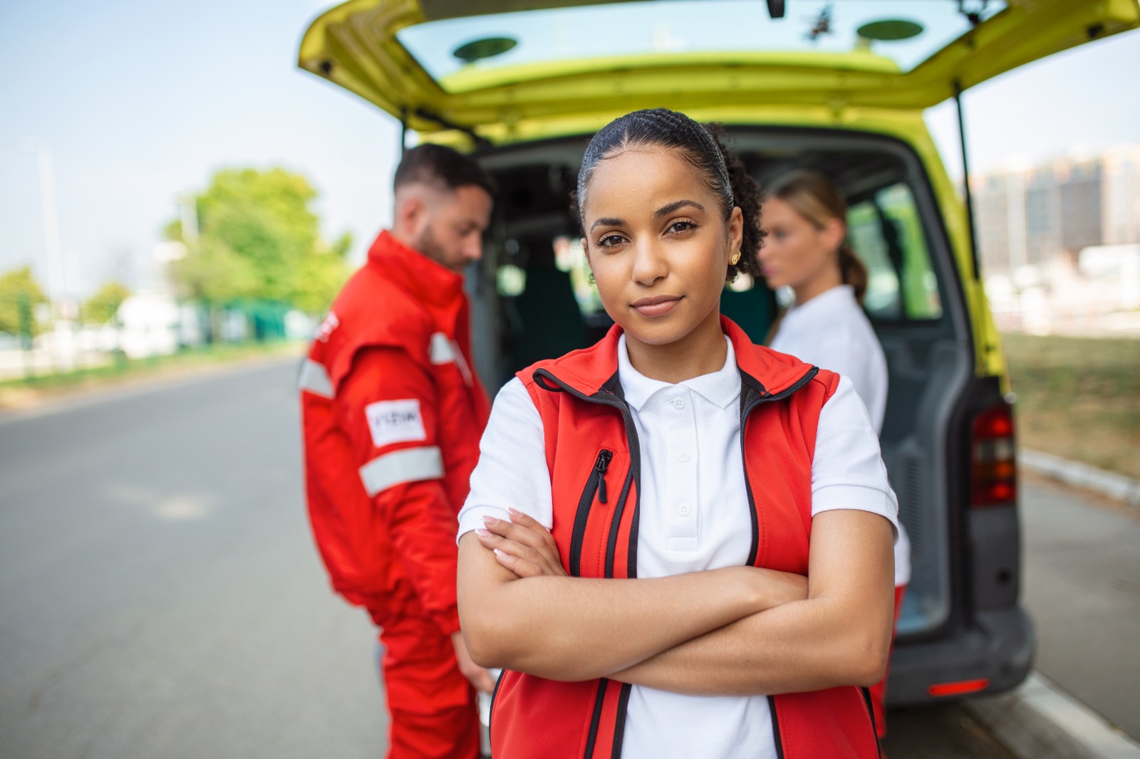 First responders standing beside an ambulance
